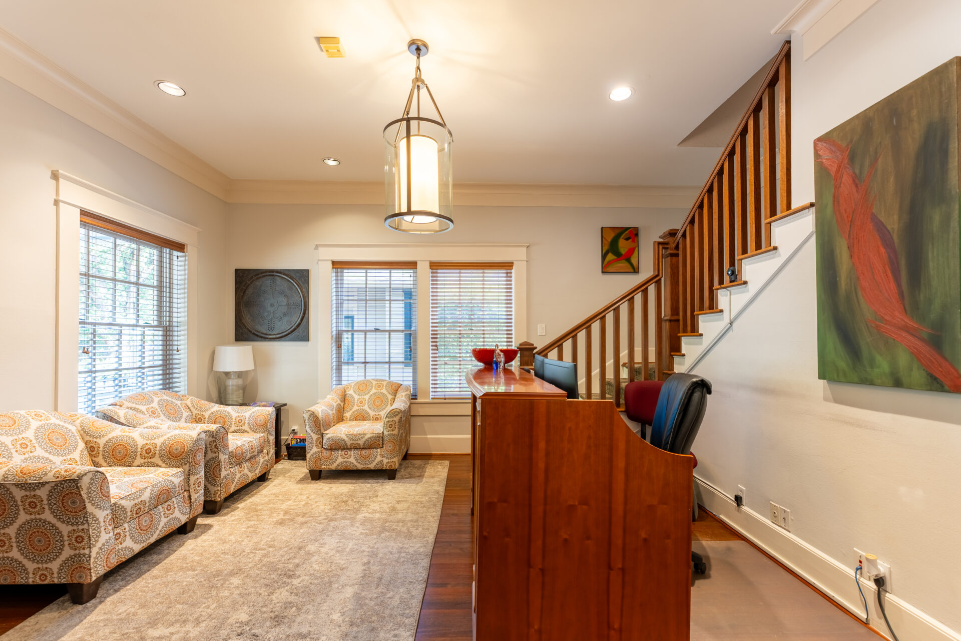 A living room with a couch, chair and television.